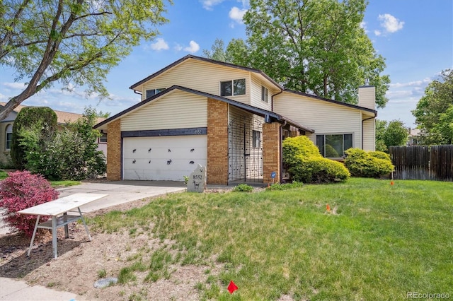 8552 Gray Ct, Arvada, CO 80003 - view of front of home with a garage, driveway, a chimney, and brick siding