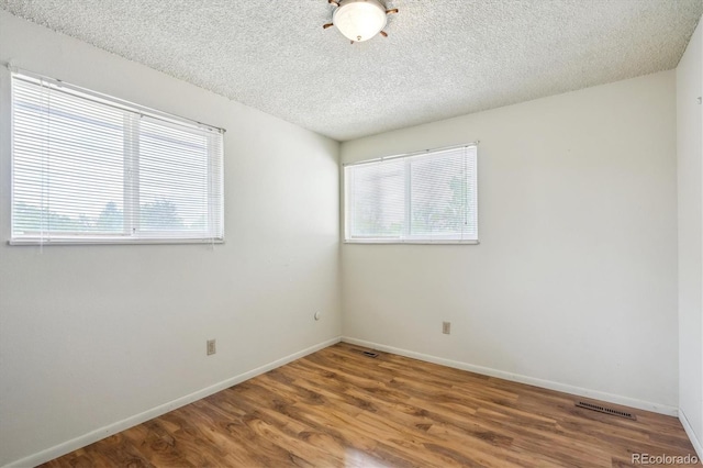 8552 Gray Ct, Arvada, CO 80003 - empty room featuring wood finished floors, a textured ceiling, and baseboards