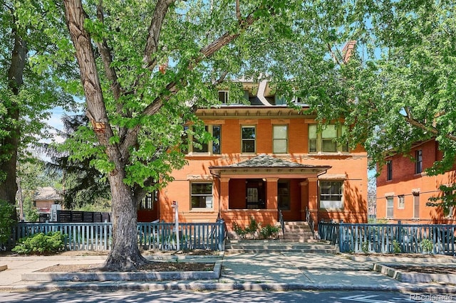 1401 N Franklin St Unit 1, Denver, CO 80218 - view of front facade featuring covered porch and a fenced front yard