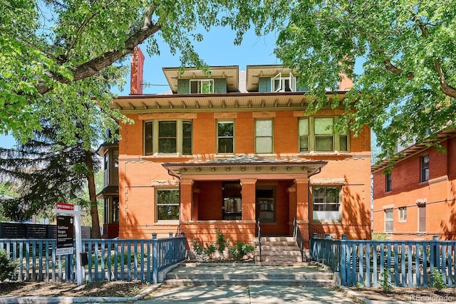 1401 N Franklin St Unit 1, Denver, CO 80218 - view of front of property featuring brick siding, fence, and covered porch