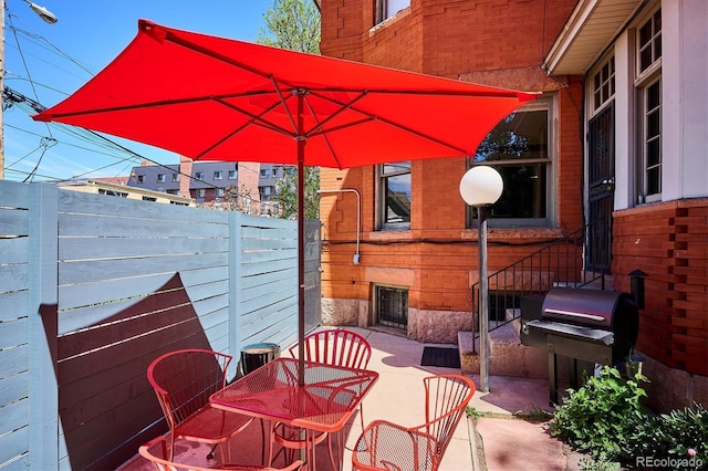 1401 N Franklin St Unit 1, Denver, CO 80218 - view of patio featuring fence, a grill, and outdoor dining area