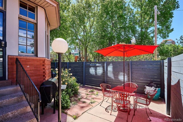 1401 N Franklin St Unit 1, Denver, CO 80218 - view of patio featuring a fenced backyard and outdoor dining area