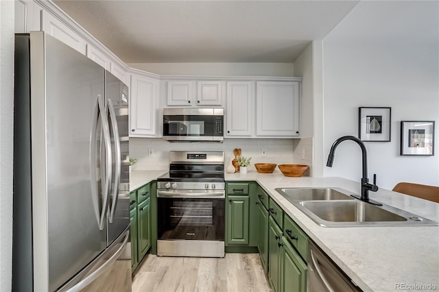 2642 Devonshire Ct, Denver, CO 80229 - kitchen featuring appliances with stainless steel finishes, green cabinetry, a sink, and light countertops