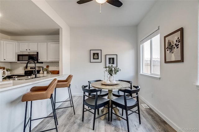 2642 Devonshire Ct, Denver, CO 80229 - dining area with ceiling fan, wood finished floors, and baseboards