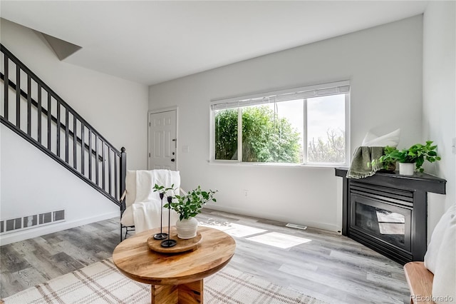 2642 Devonshire Ct, Denver, CO 80229 - entrance foyer featuring stairs, a glass covered fireplace, wood finished floors, and baseboards