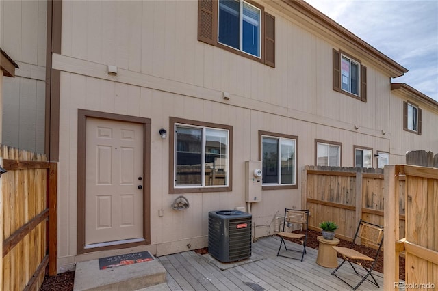 2642 Devonshire Ct, Denver, CO 80229 - entrance to property with central air condition unit and a wooden deck