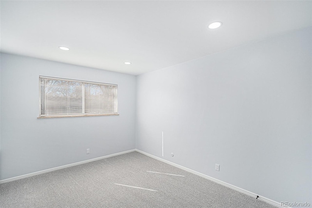 carpeted empty room featuring recessed lighting and baseboards