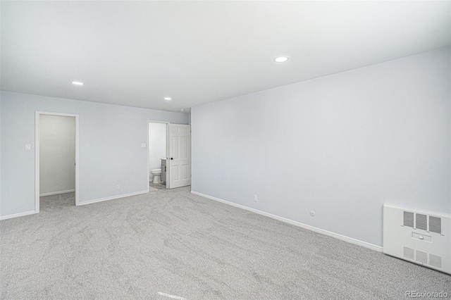 spare room with carpet floors, recessed lighting, visible vents, and baseboards