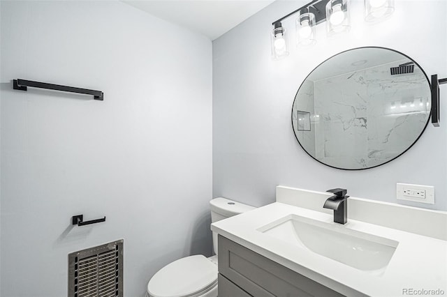 bathroom with toilet, heating unit, visible vents, and vanity