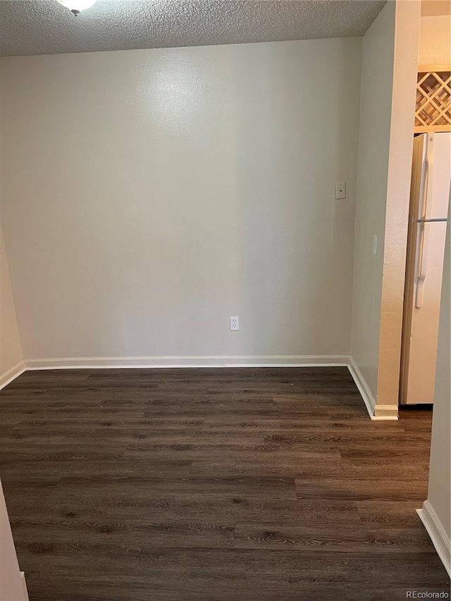 14704 E 2nd Ave Unit 300E, Aurora, CO 80011 - empty room with dark wood-type flooring and a textured ceiling