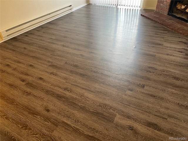 14704 E 2nd Ave Unit 300E, Aurora, CO 80011 - detailed view of wood finished floors, a baseboard radiator, and a fireplace