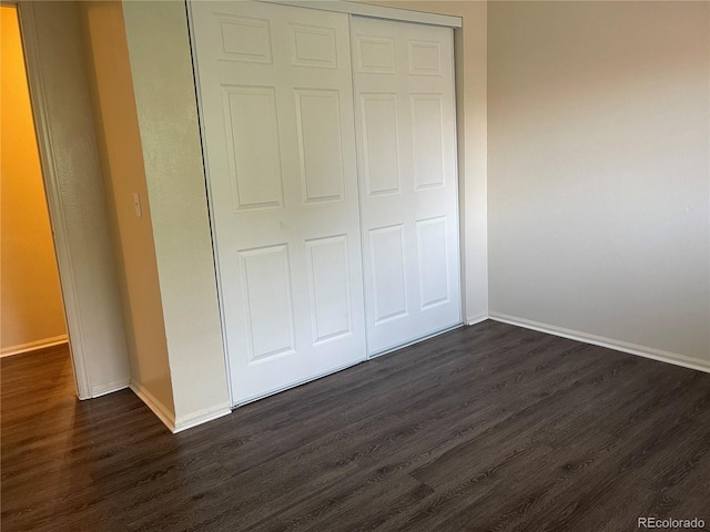 14704 E 2nd Ave Unit 300E, Aurora, CO 80011 - unfurnished bedroom with dark wood-style flooring and a closet