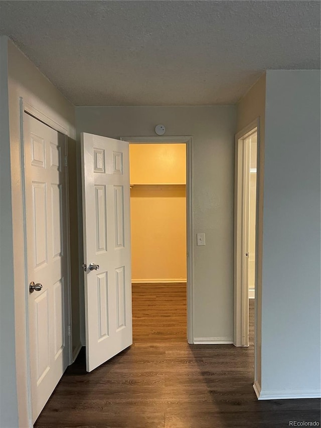 14704 E 2nd Ave Unit 300E, Aurora, CO 80011 - hall featuring dark wood finished floors and a textured ceiling