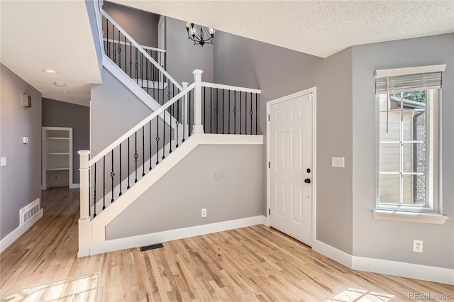 5370 S Jebel St, Centennial, CO 80015 - entryway featuring wood finished floors, stairs, a chandelier, a textured ceiling, and recessed lighting