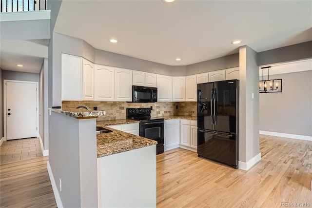 5370 S Jebel St, Centennial, CO 80015 - kitchen featuring black appliances, dark stone countertops, white cabinetry, a peninsula, and recessed lighting