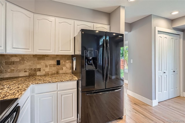 5370 S Jebel St, Centennial, CO 80015 - kitchen featuring black fridge, light stone counters, light wood-style flooring, white cabinets, and recessed lighting