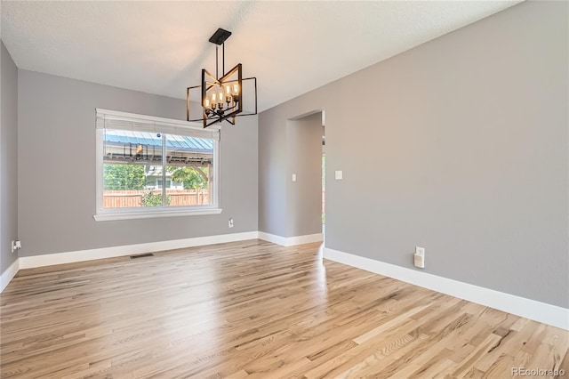 5370 S Jebel St, Centennial, CO 80015 - spare room featuring a chandelier and light wood-style floors