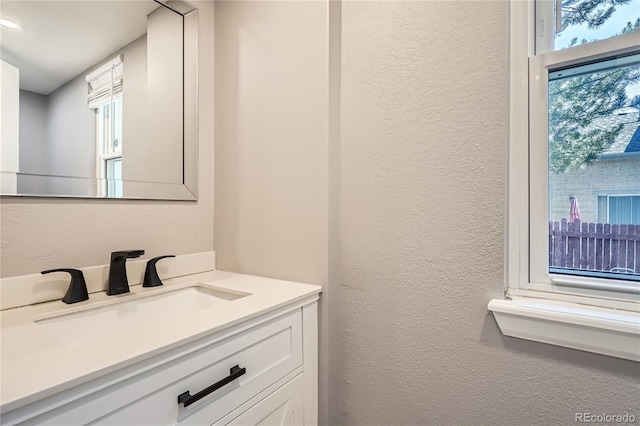 5370 S Jebel St, Centennial, CO 80015 - bathroom featuring healthy amount of natural light, vanity, a textured wall, and recessed lighting