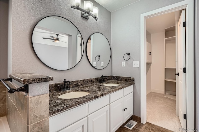 5370 S Jebel St, Centennial, CO 80015 - full bath with double vanity, a ceiling fan, and a textured wall