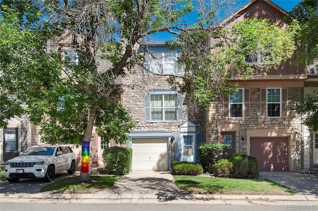 2973 W 81st Ave Unit D, Westminster, CO 80031 - townhome / multi-family property featuring stone siding, a garage, and driveway