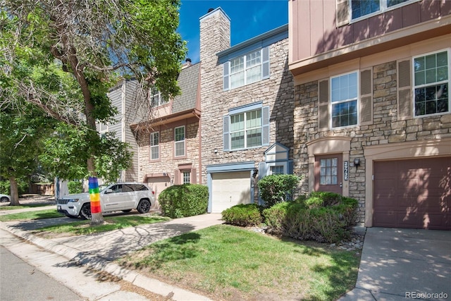 2973 W 81st Ave Unit D, Westminster, CO 80031 - townhome / multi-family property featuring stone siding, driveway, and a garage