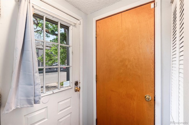 2973 W 81st Ave Unit D, Westminster, CO 80031 - doorway to outside with a textured ceiling