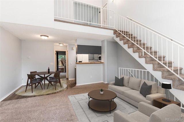 2973 W 81st Ave Unit D, Westminster, CO 80031 - carpeted living room with stairs and a towering ceiling