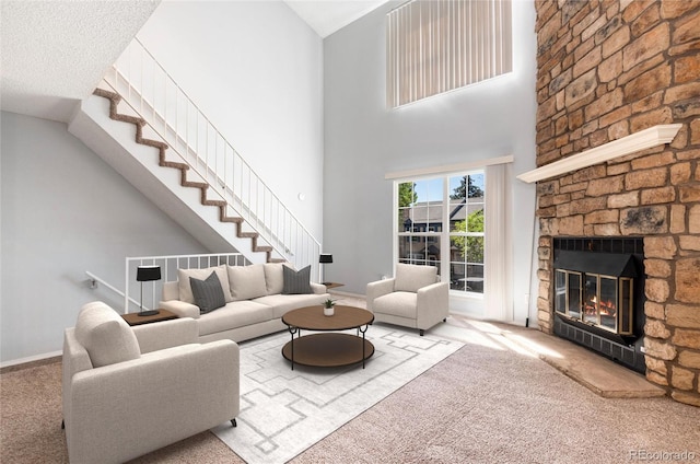 2973 W 81st Ave Unit D, Westminster, CO 80031 - carpeted living area with a stone fireplace, stairway, and a towering ceiling