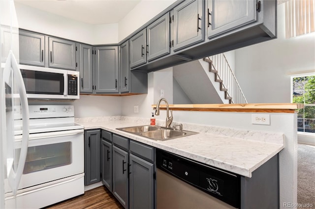 2973 W 81st Ave Unit D, Westminster, CO 80031 - kitchen featuring electric range, stainless steel dishwasher, gray cabinetry, light countertops, and dark wood-style flooring