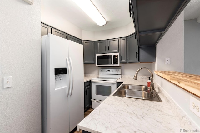 2973 W 81st Ave Unit D, Westminster, CO 80031 - kitchen featuring white appliances, light countertops, and dark wood-style flooring