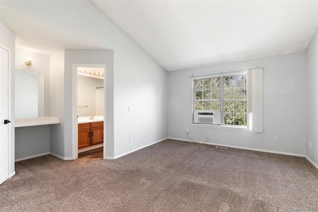 2973 W 81st Ave Unit D, Westminster, CO 80031 - unfurnished bedroom with carpet, cooling unit, vaulted ceiling, ensuite bathroom, and a textured ceiling