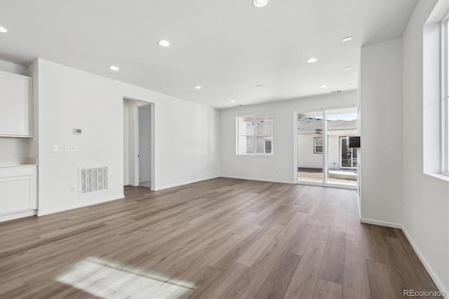 unfurnished living room with light wood-type flooring