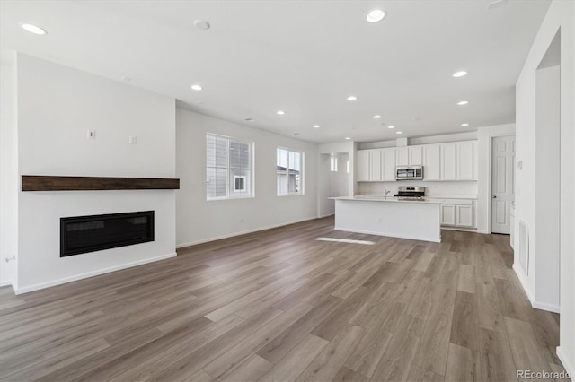 unfurnished living room featuring light hardwood / wood-style floors