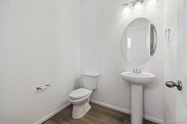 bathroom featuring sink, hardwood / wood-style flooring, and toilet