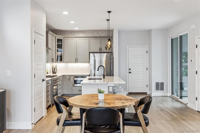 dining space with visible vents, baseboards, and light wood-type flooring