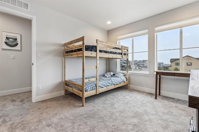 carpeted bedroom with visible vents, baseboards, and recessed lighting
