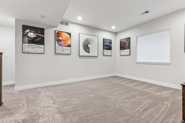 carpeted spare room with recessed lighting, visible vents, and baseboards