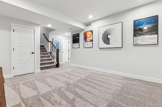 interior space with baseboards, carpet, visible vents, and stairs