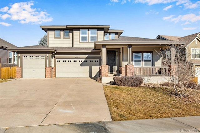 view of front of home with a front lawn, a porch, and a garage