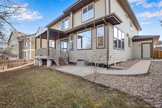 rear view of property featuring a yard