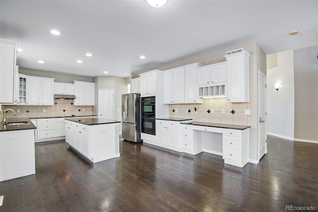 kitchen featuring black double oven, dark wood-type flooring, white cabinets, stainless steel fridge with ice dispenser, and a kitchen island