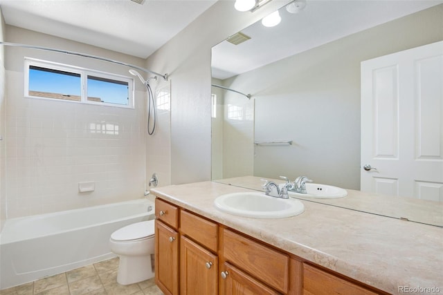 full bathroom featuring tile patterned floors, vanity, toilet, and tiled shower / bath