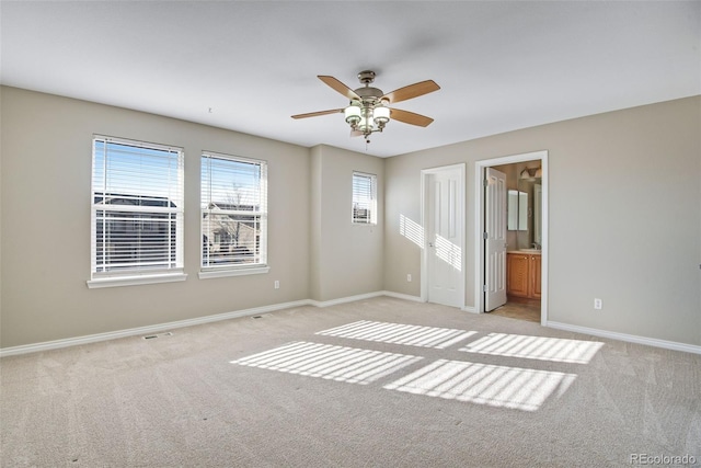 empty room featuring light colored carpet and ceiling fan