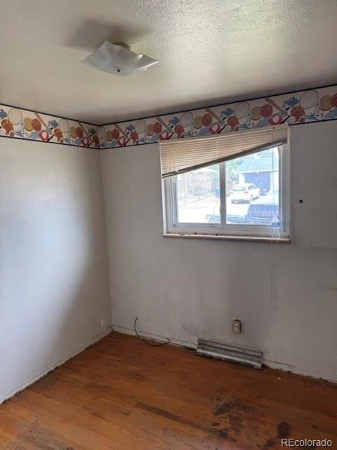 8250 Ralph Ln, Denver, CO 80221 - spare room with light wood finished floors and a textured ceiling