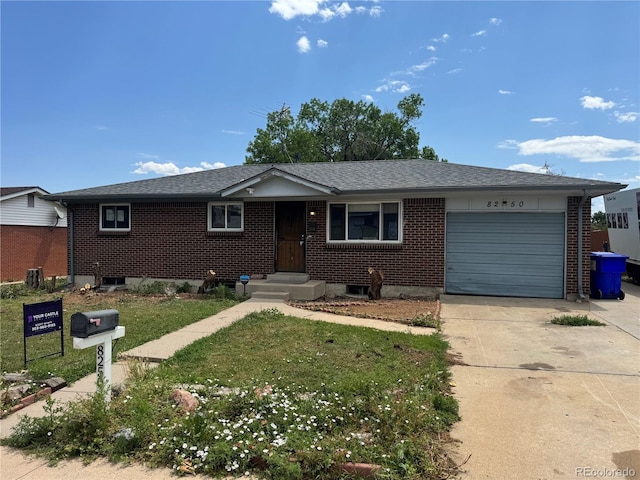 8250 Ralph Ln, Denver, CO 80221 - ranch-style house with an attached garage, brick siding, driveway, a front lawn, and a shingled roof
