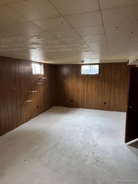 8250 Ralph Ln, Denver, CO 80221 - basement featuring plenty of natural light and wood walls