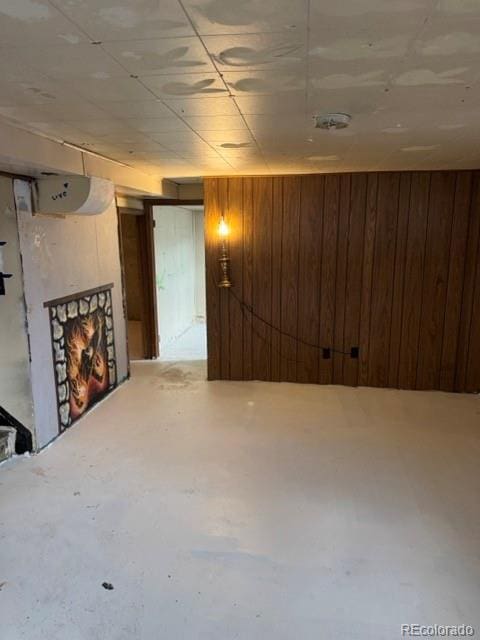 8250 Ralph Ln, Denver, CO 80221 - unfinished basement with wood walls and a fireplace