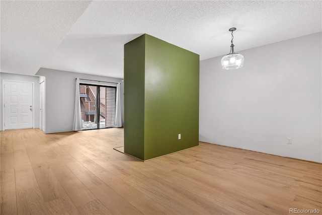 interior space with light wood-type flooring and a textured ceiling