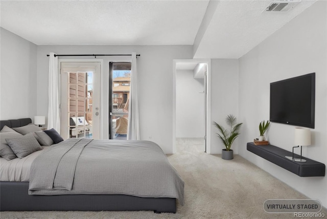 carpeted bedroom featuring visible vents and access to exterior