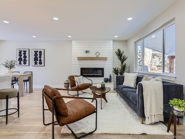 living room featuring light hardwood / wood-style flooring and a fireplace